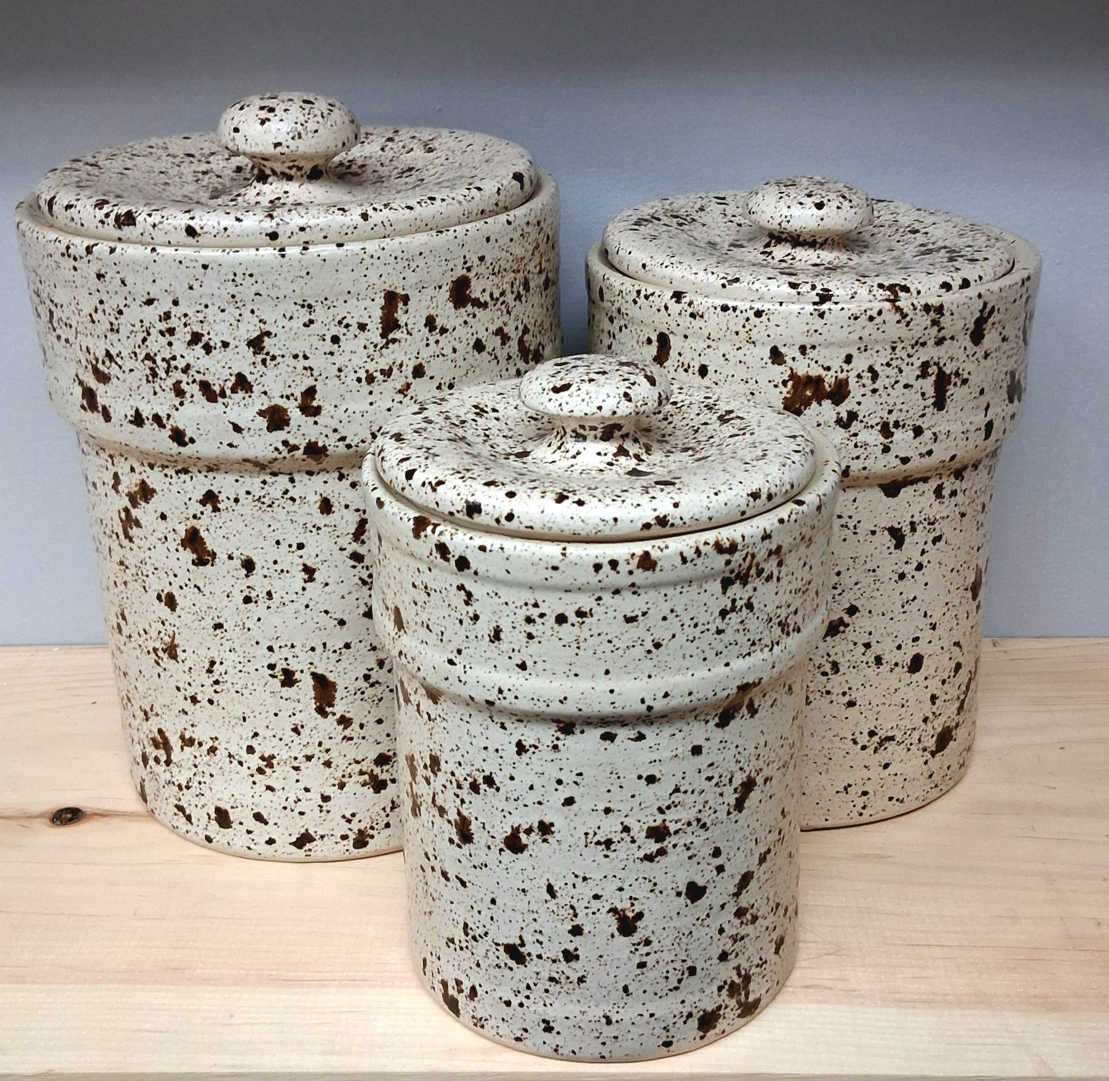 Set of three ceramic canisters with speckled glaze (Texas)