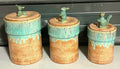 Three ceramic canisters with animal-shaped handles