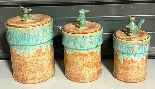 Three ceramic canisters with animal-shaped handles